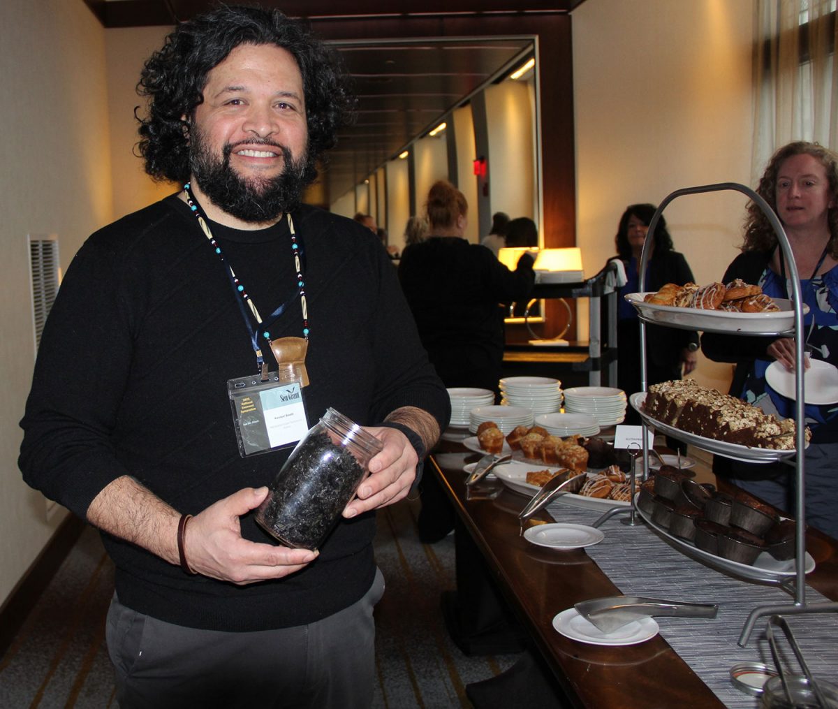 Keolani Booth shared a jar of dried seaweed he harvested to sprinkle on salad at the lunch buffet.